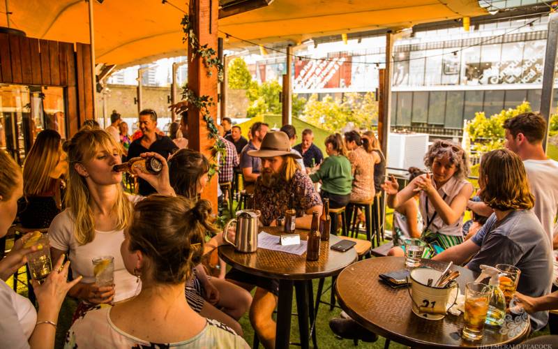 Image of patrons at The Emerald Peacock Rooftop Bar.