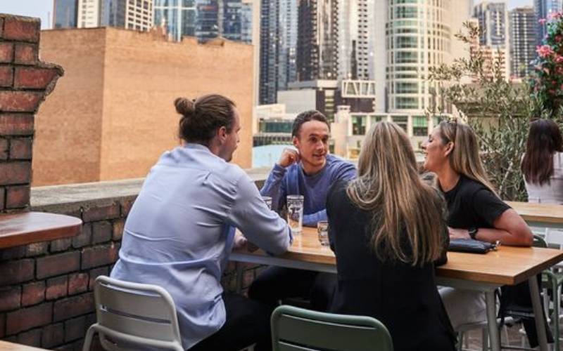 Rooftop image of people outdoors at State of Grace Rooftop Bar.