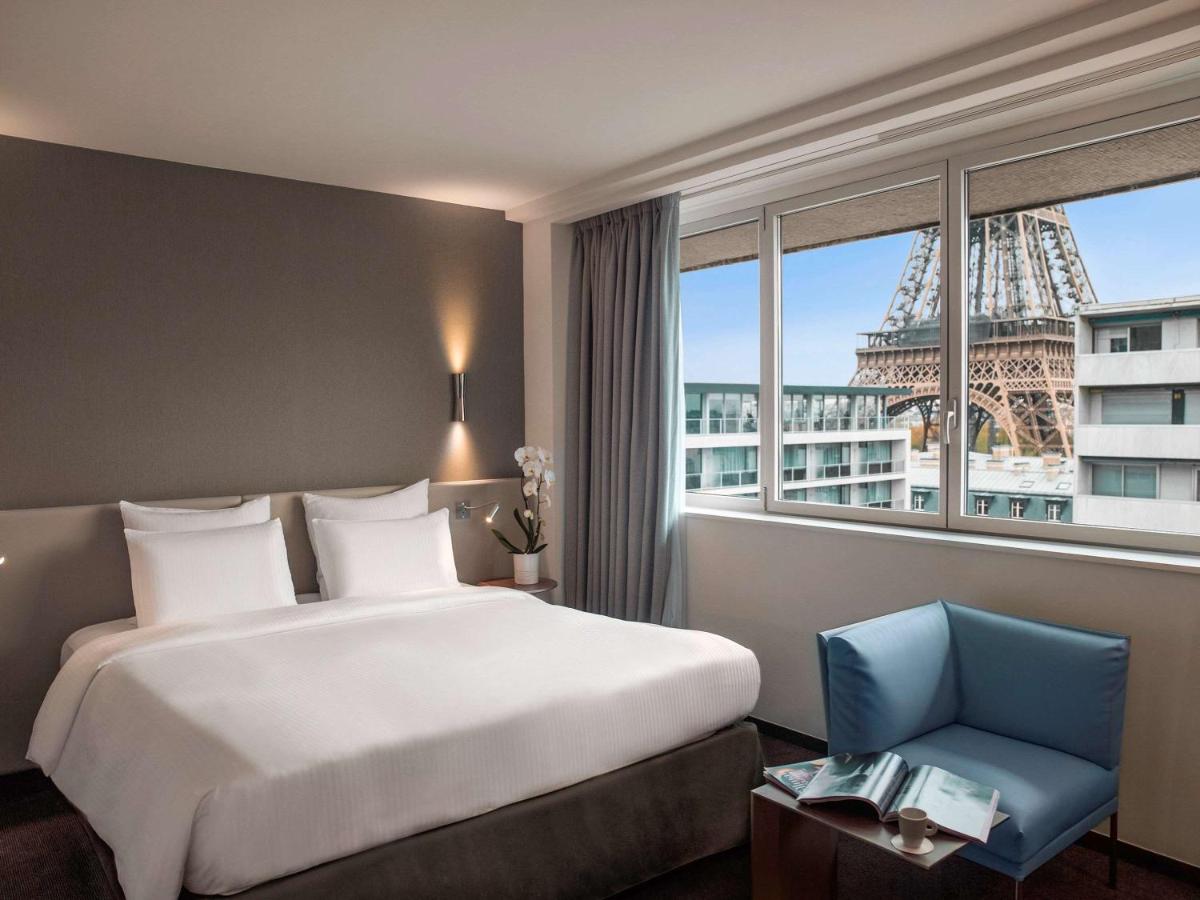 Hotel Room Bed with View of the Eiffel Tower in Paris