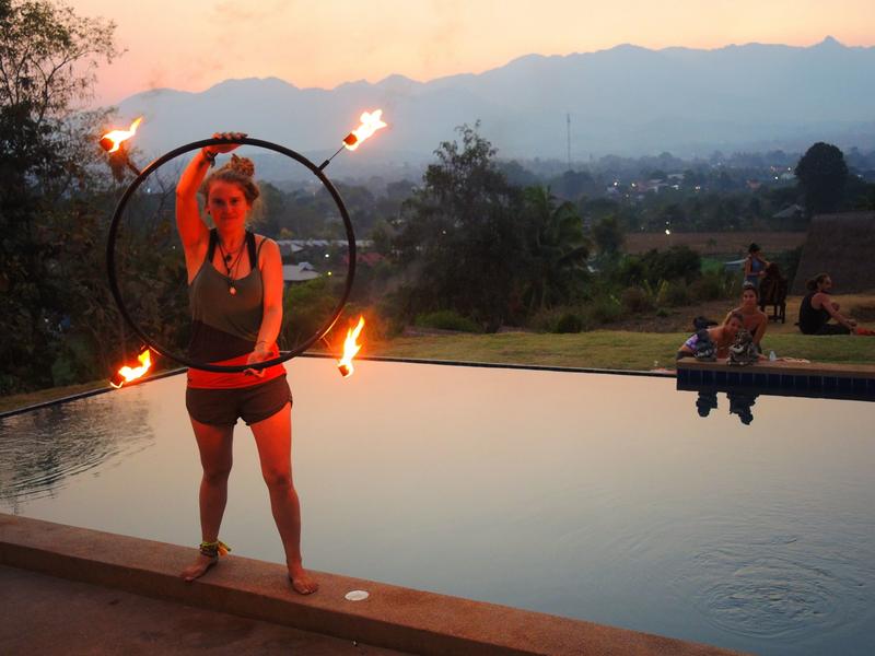 Image of a lady spinning a fire wheel.