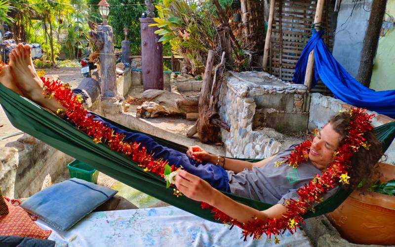 Image of man lying on hammock at Sunny Tayai Hostel Pai.