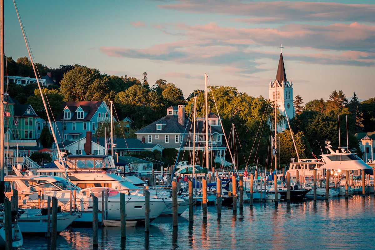 The Marina at Mackinac Island with Saint Anne's church and the historic Victorian houses a sunset shot from Lake Michigan