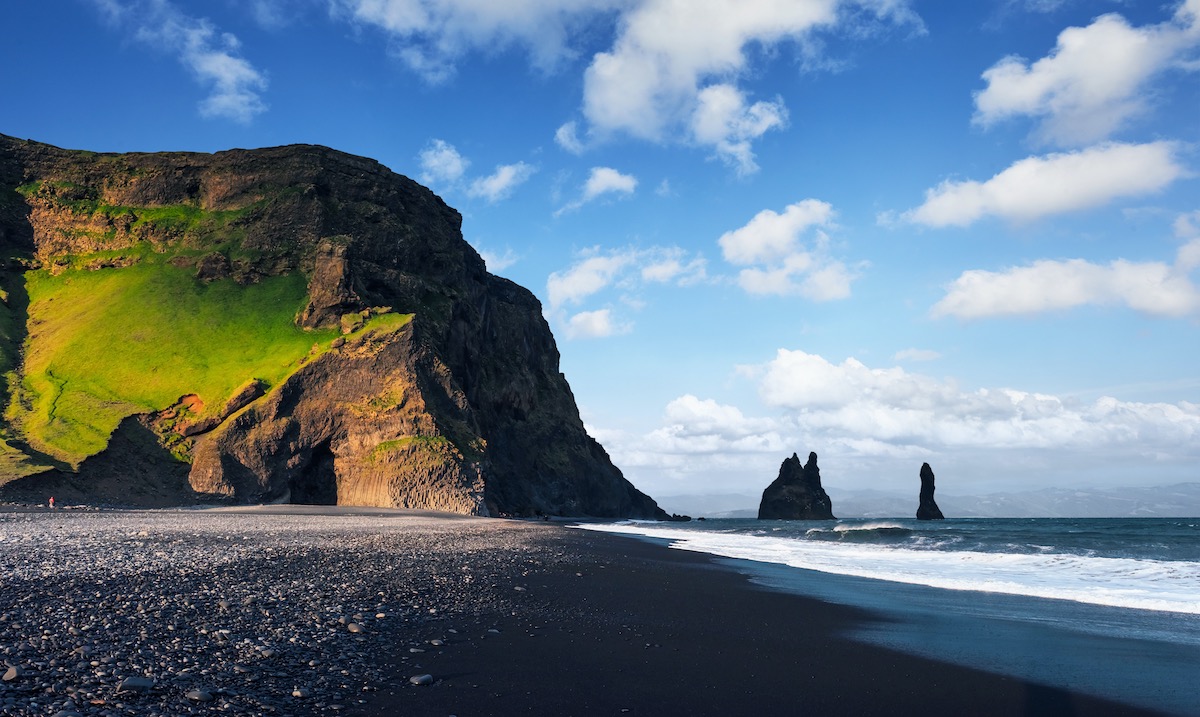 Famous Reynisdrangar rock formations at black Reynisfjara Beach. Coast of the Atlantic ocean near Vik, southern Iceland