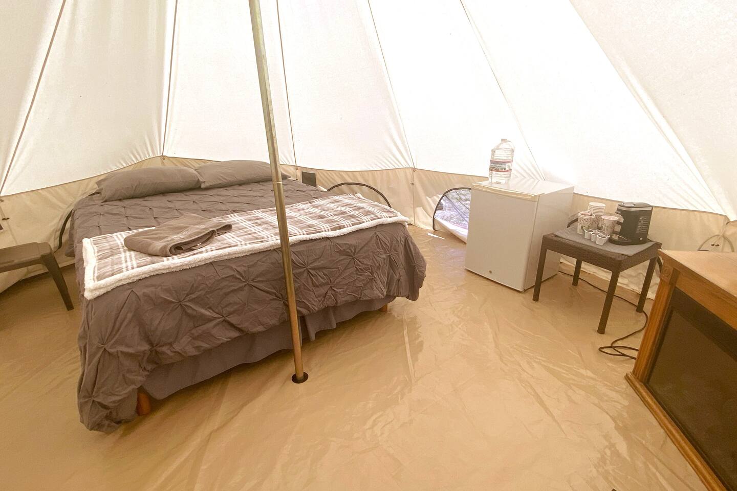 Bed inside a glamping tent