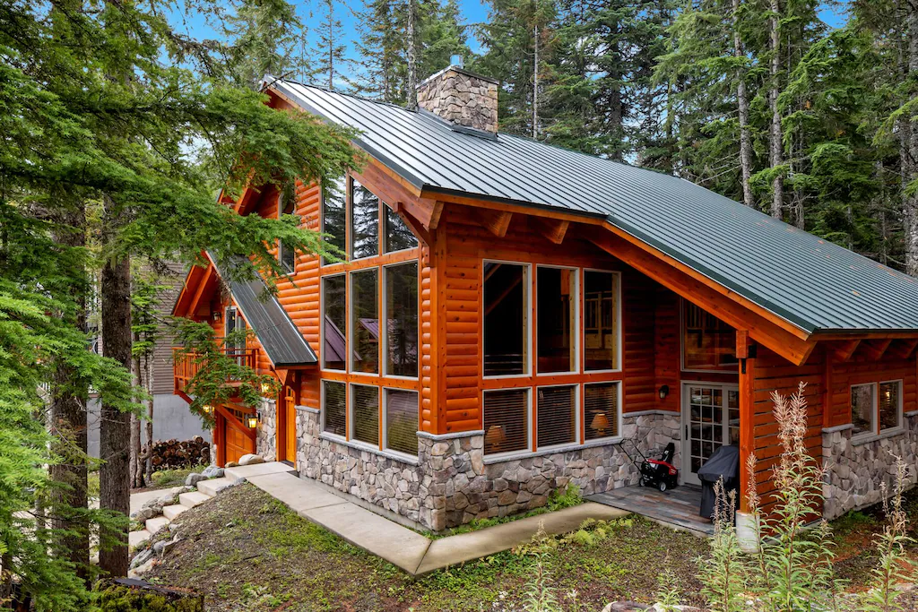 The cabin is surrounded by greenery