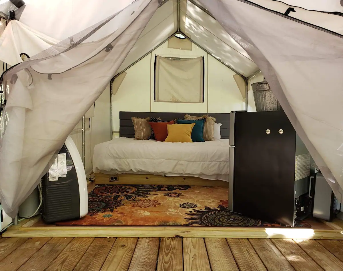 Bed inside a glamping tent